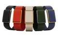 Four woven fabric watch straps in black, red, cream, and green, paired with rectangular gold-tone metal cases, arranged side by side on a white background.